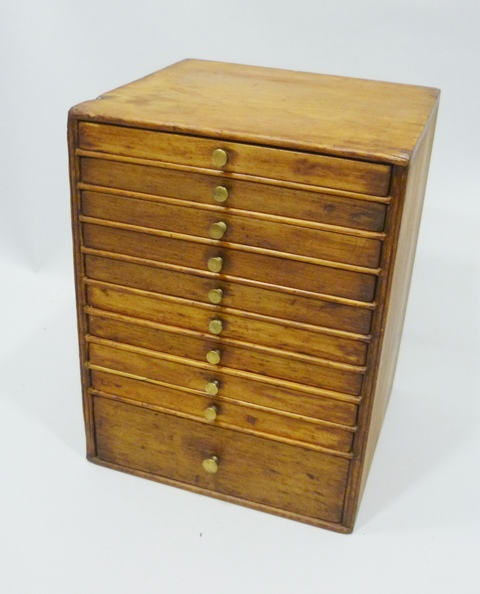 A 19TH CENTURY SOFTWOOD SPECIMEN/TRINKET CABINET having nine uniform shallow drawers and one