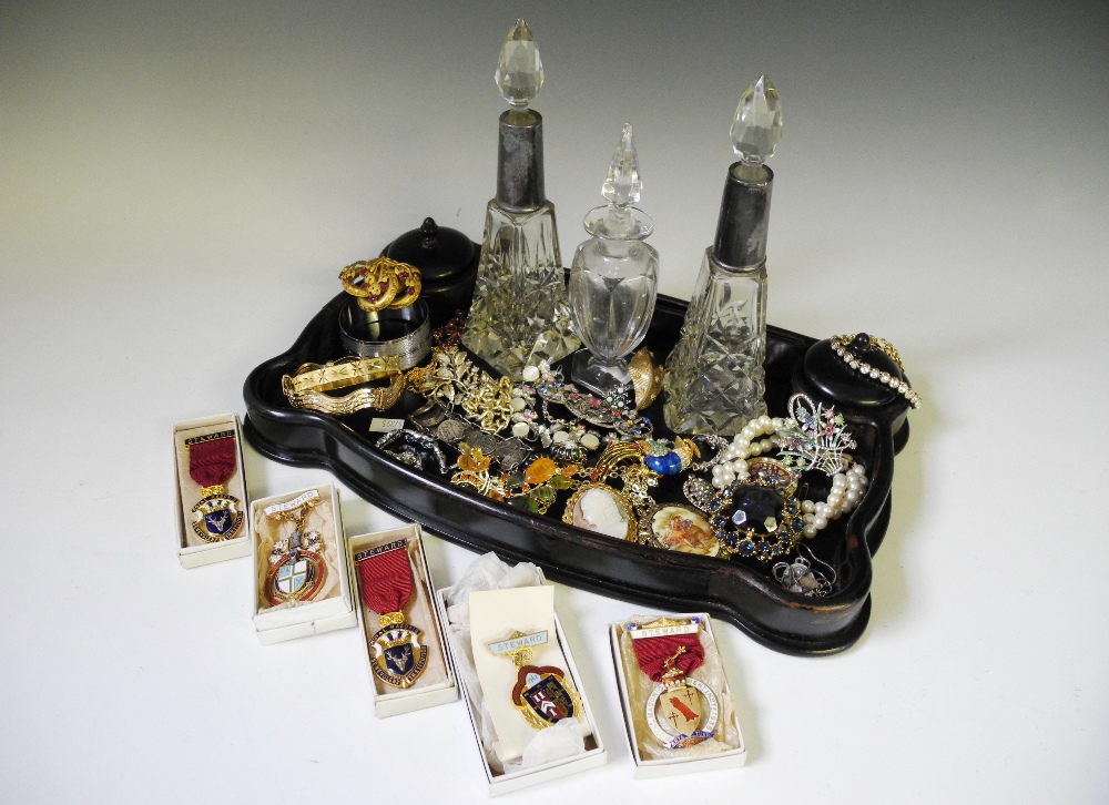 An ebonised dressing table set, including two cut glass bottles with silver collars, hallmarked H.