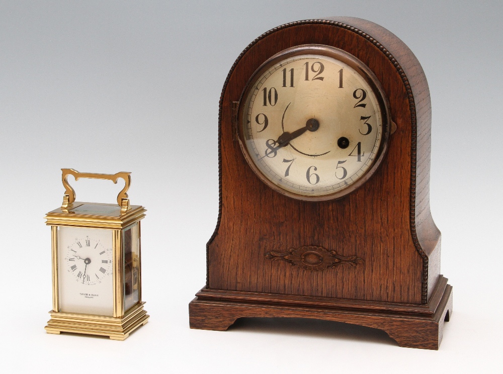 Two clocks, one a 20th Century brass carriage clock marked `Taylor and Bligh, England`, footed