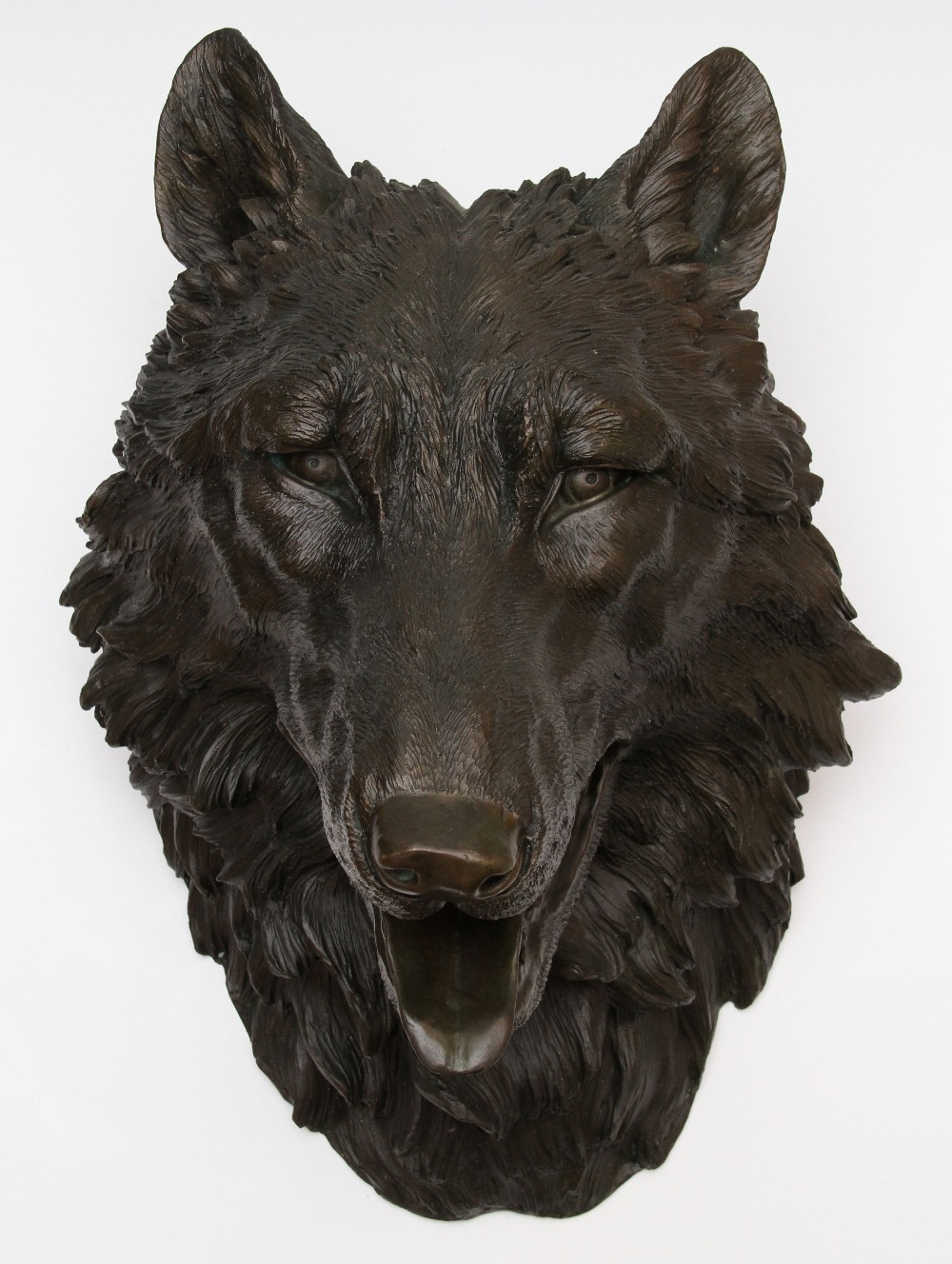 A 20th Century bronze wall mounted wolf`s head, unsigned, approx. 41cm high.