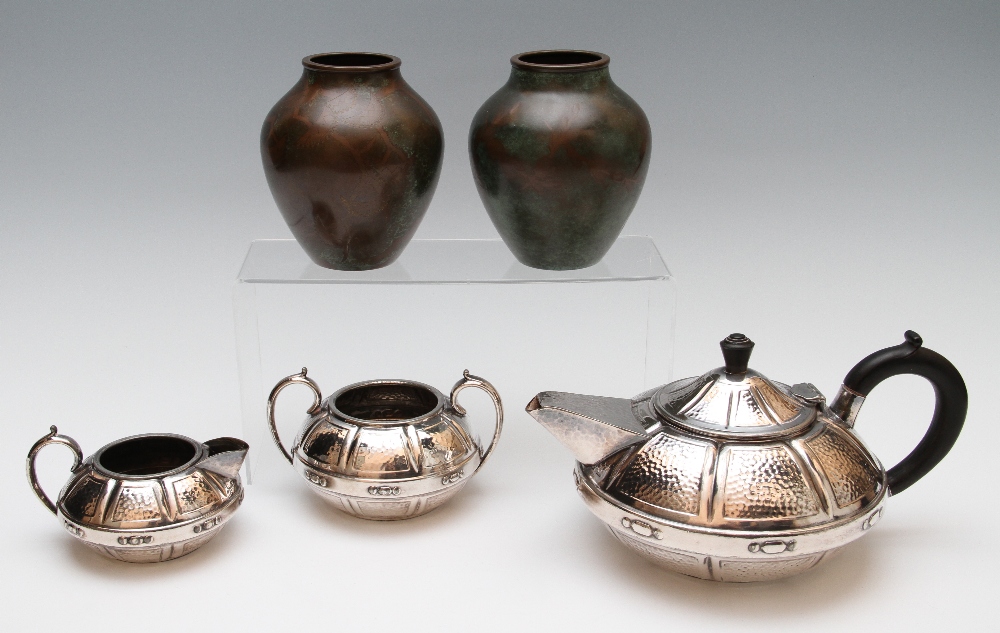 A group of metalware to include two WMF bronze patinated vases, one with foliate design, the other