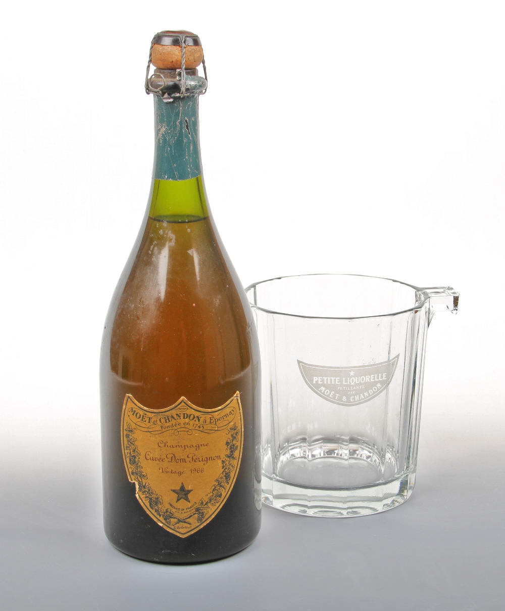 A bottle of Dom Perignon 1966 vintage champagne in a glass Moet & Chandon wine cooler