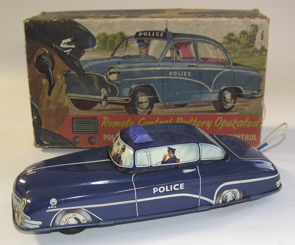 A boxed Welsotoys tinplate battery operated remote control Police Car.