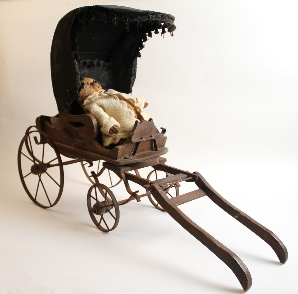 A Vintage wooden Victorian pram with metal wheels and a parasol together with a 12" teddy bear.
