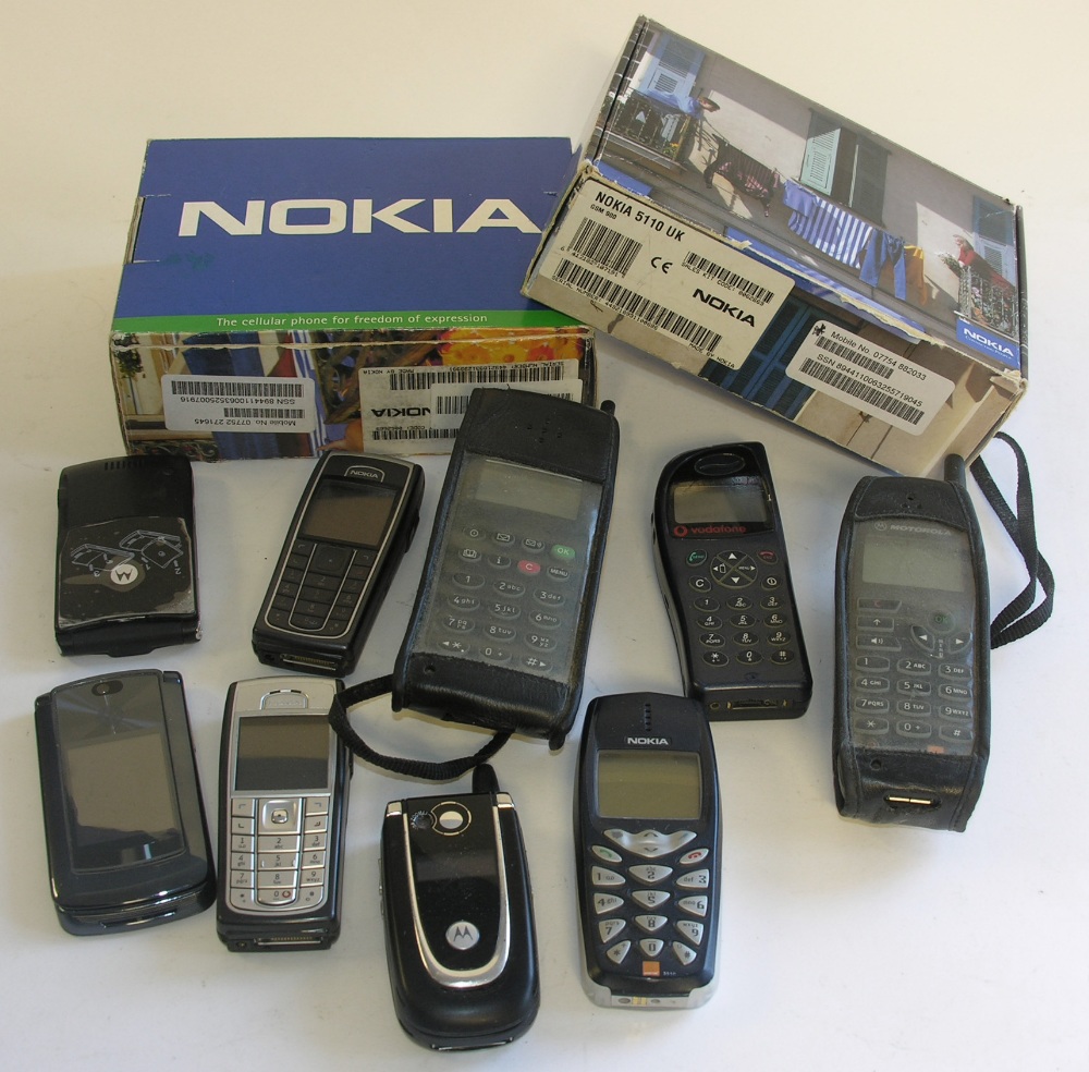 A collection of eleven old mobile telephones.