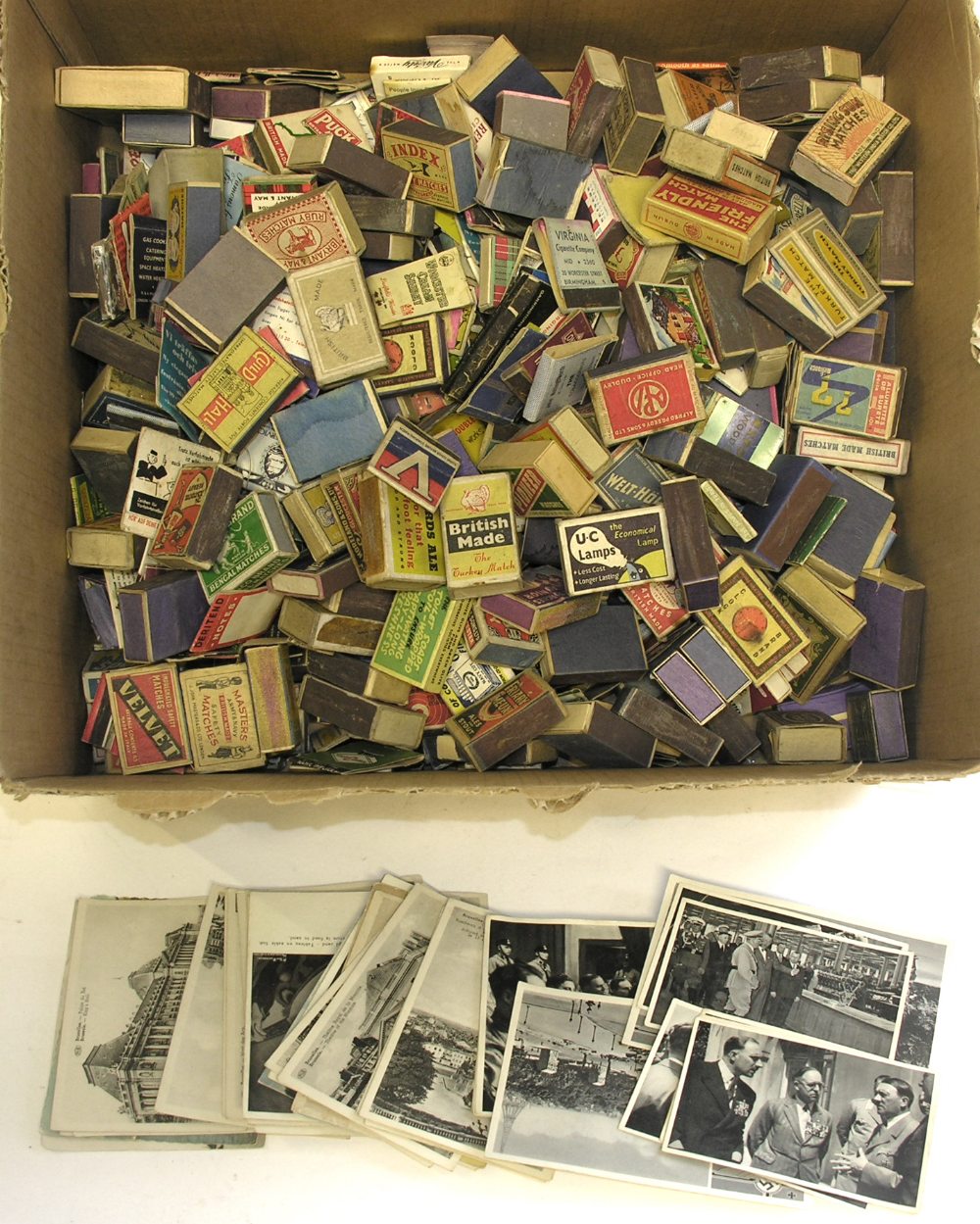 A quantity of various empty matchboxes, a small collection of postcards and German WWII trade cards.