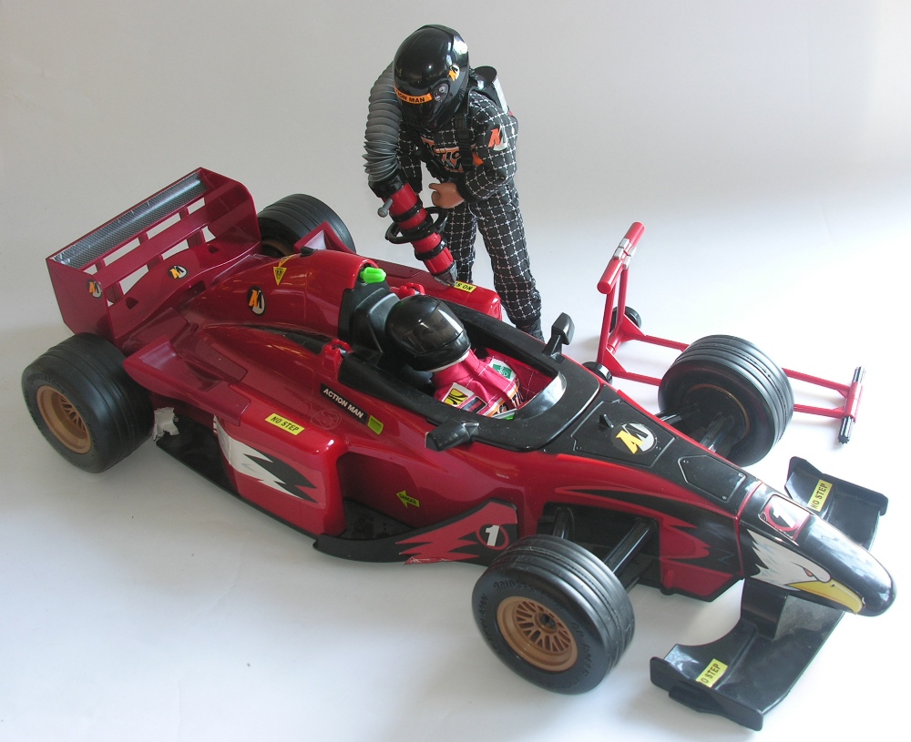 An Action Man style racing car with jack, driver and petrol refueller figures.