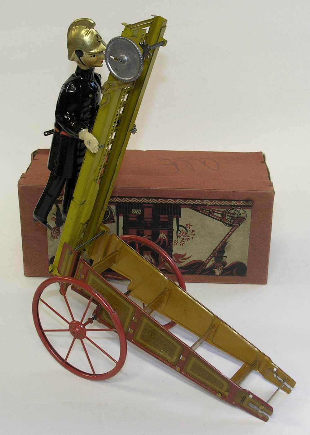 A boxed c1930`sGama tinplate clockwork climbing fireman with ladder cart.