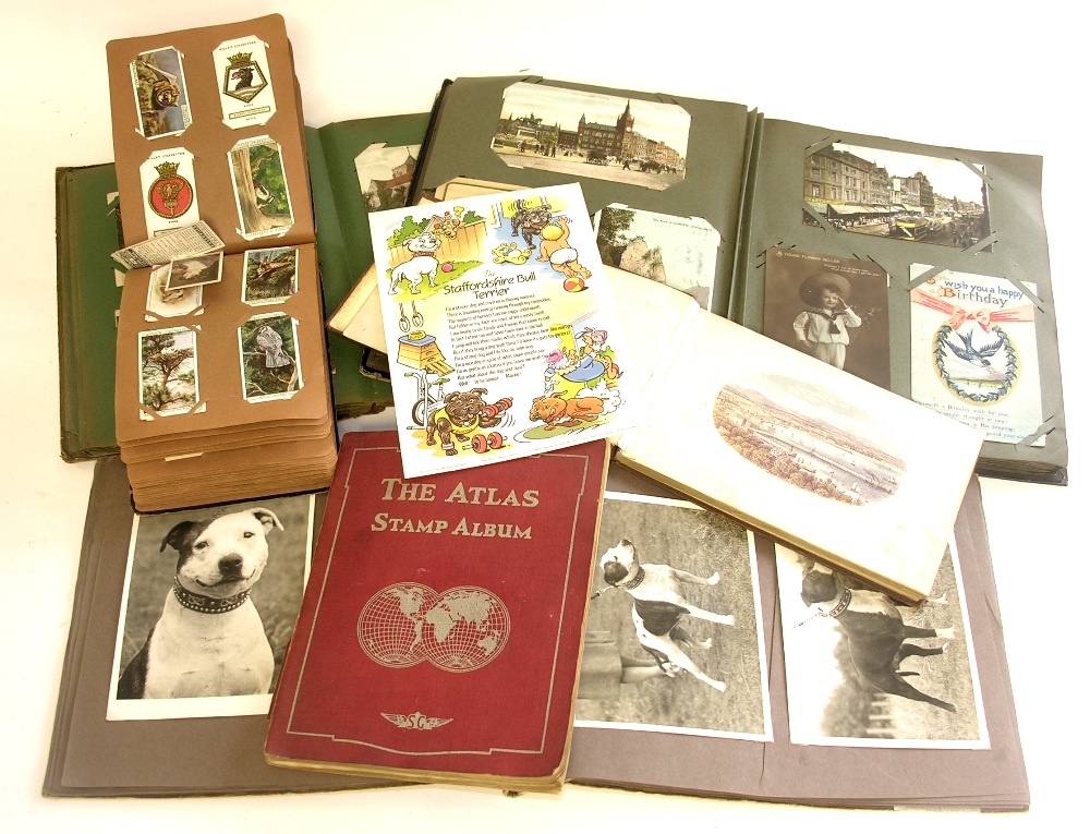 A collection of postcards, both loose and in an album, cigarette and tea cards, photograph album,