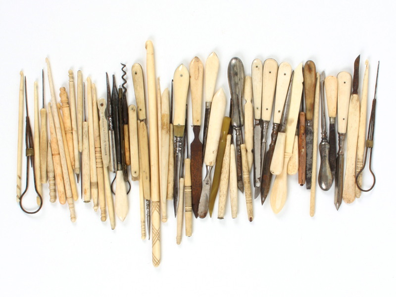 A large quantity of bone and metal crochet hooks, together with other bone handled tools, mostly for