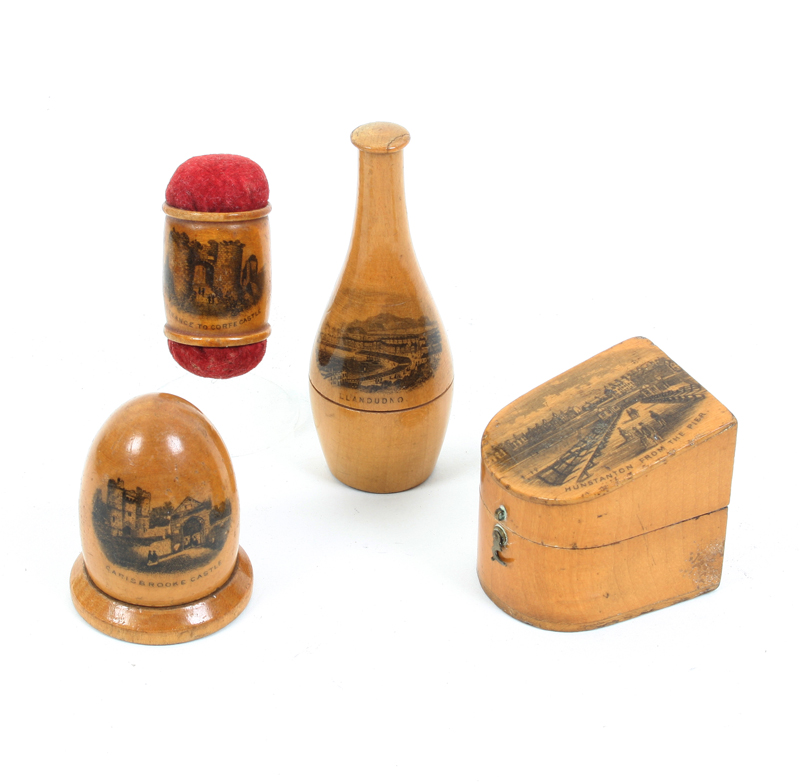 Four pieces of Mauchline ware: A slant top thimble box with composition thimble (Hunstanton from the