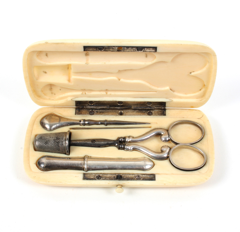 An ivory cased sewing set, the case of rounded corner rectangular form, flush fitted with silver