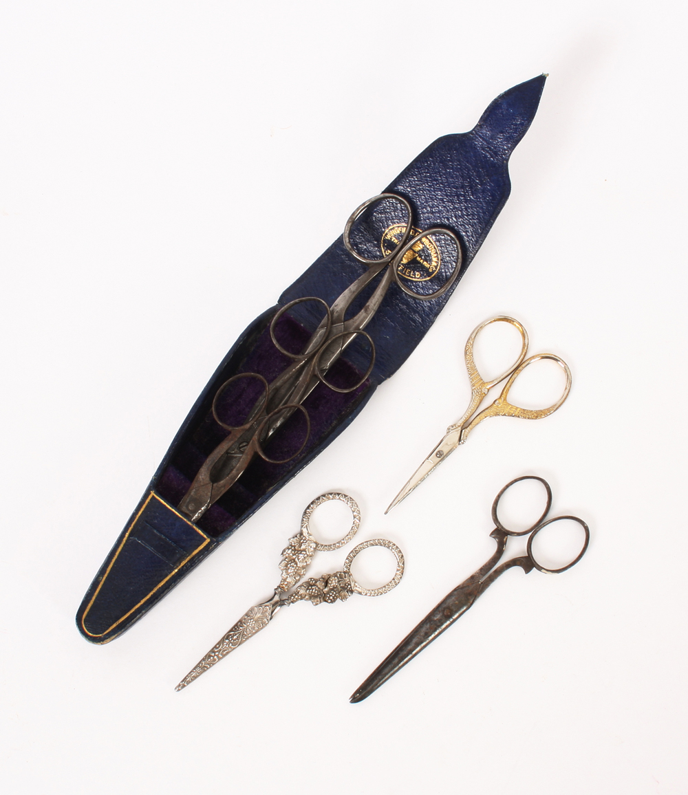 Scissors, comprising; three pairs of graduated steel scissors in a triangular leather case, 14.