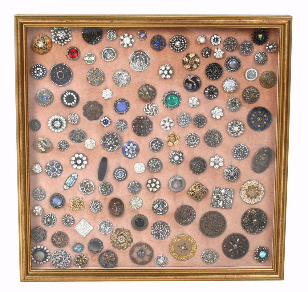 A framed display of 19th century and later buttons, including; steel, paste set and other decorative