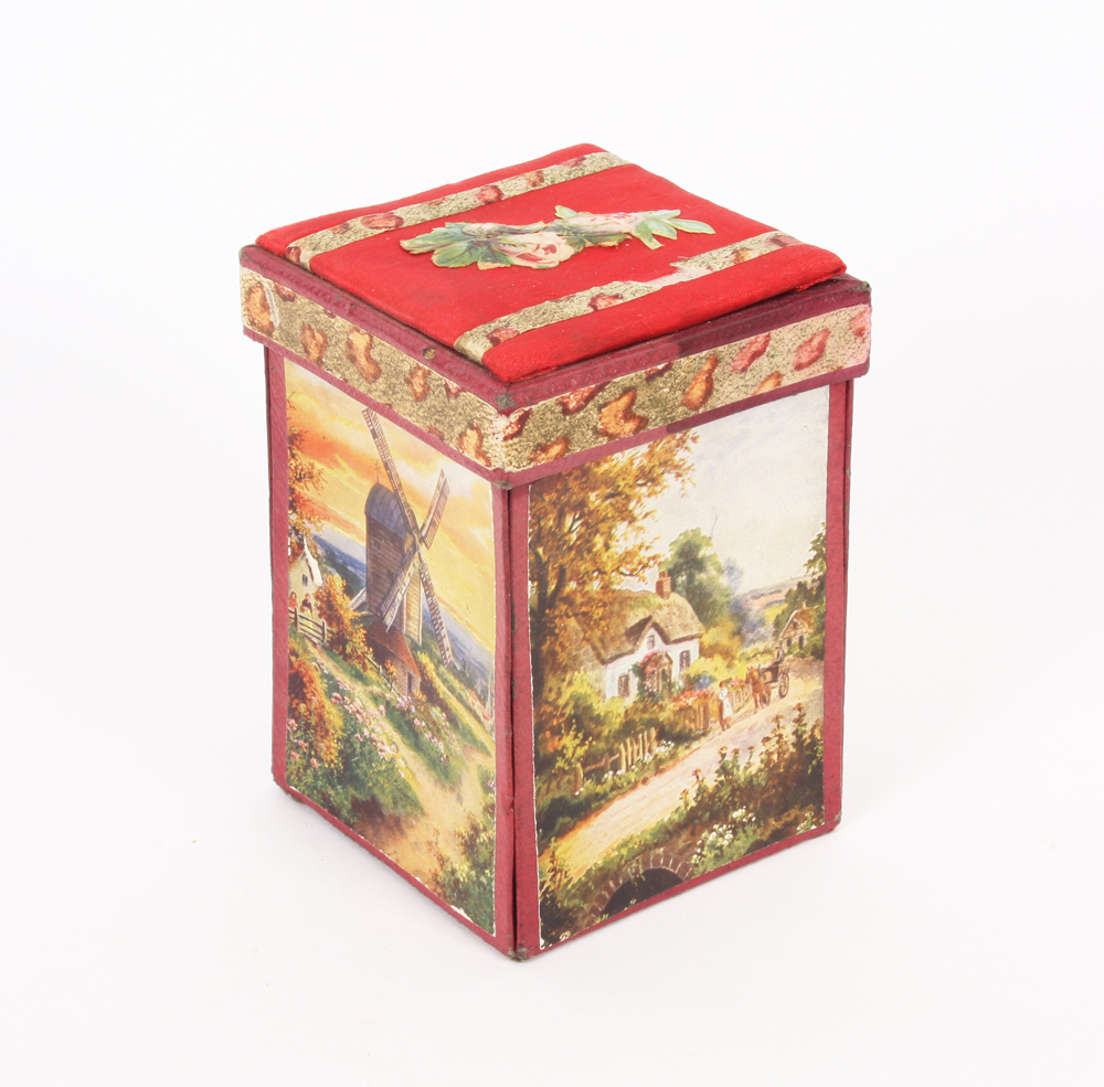 A falling side cardboard sewing companion, the hinged silk lid with floral scrap, the sides with
