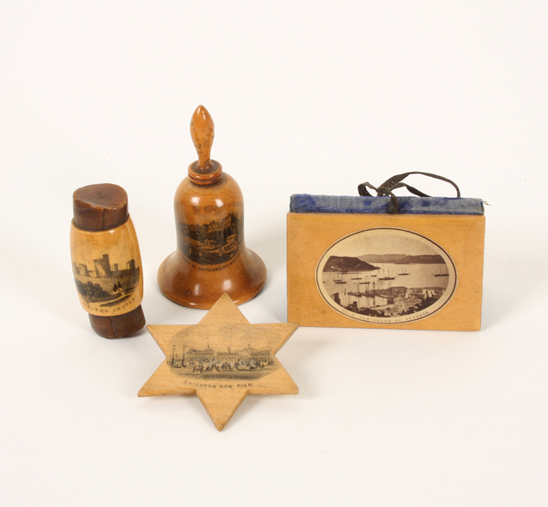 Four pieces of Mauchline ware, comprising: A star form silk winder (Brighton New Pier), 4.5cm, a