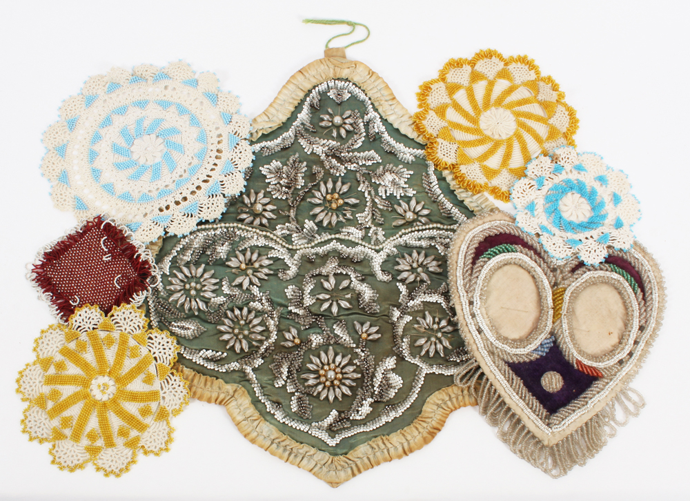 Beadwork: a large wall pocket in green silk, worked with stylised flowerheads within trailing