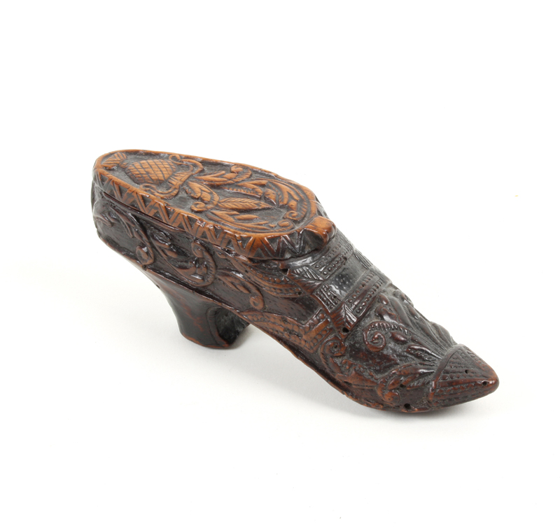A fine carved fruitwood Scottish snuff shoe, the heeled shoe well carved with leaf scrolls and