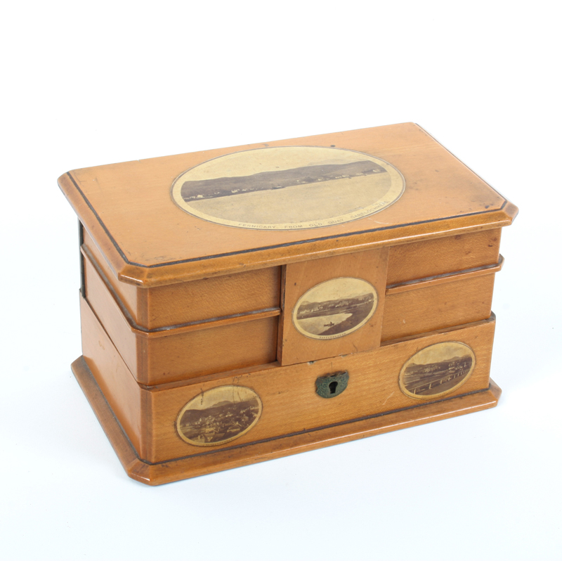 A Mauchline ware rectangular jewellery box, the hinged lid revealing four swing trays over a lower