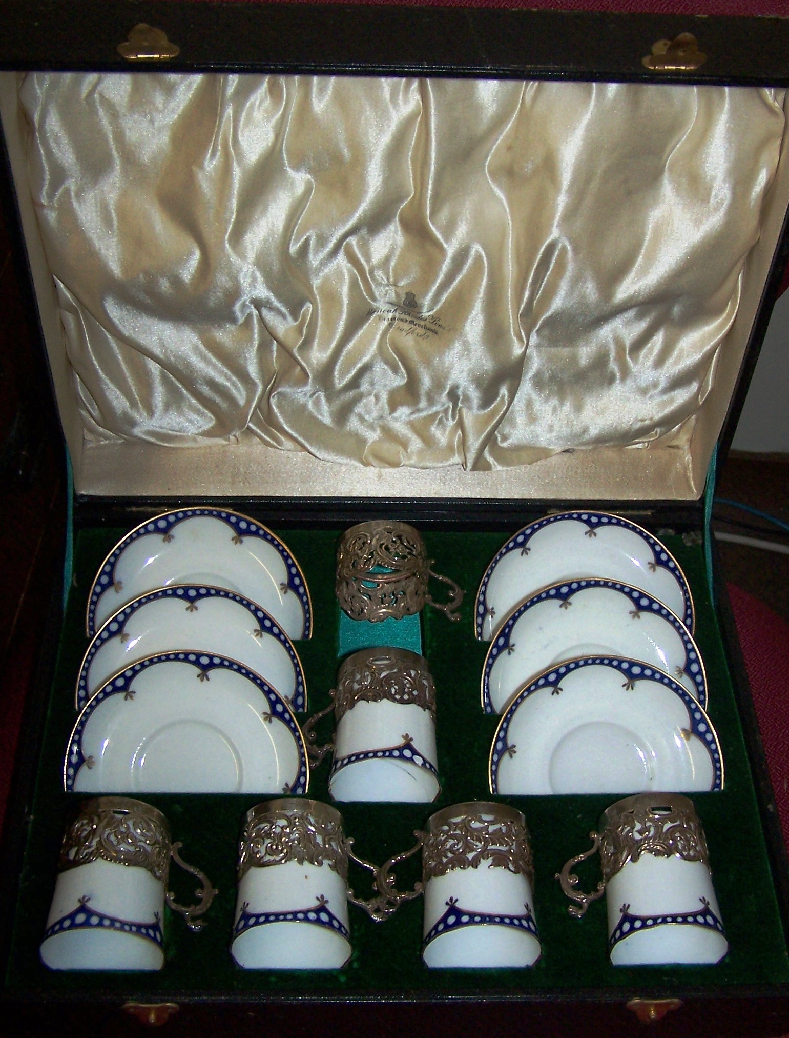 A set of five Crown Staffordshire Coffee Cans with six saucers, with a blue and white border pattern