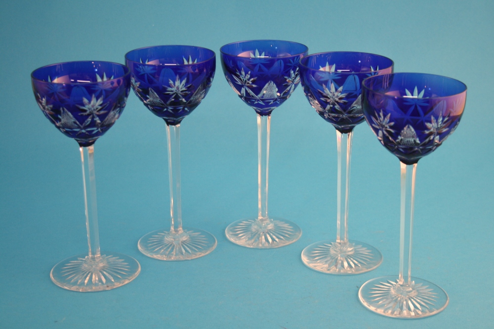 A set of five hock glasses with blue glass bowls, clear octagonal stems.