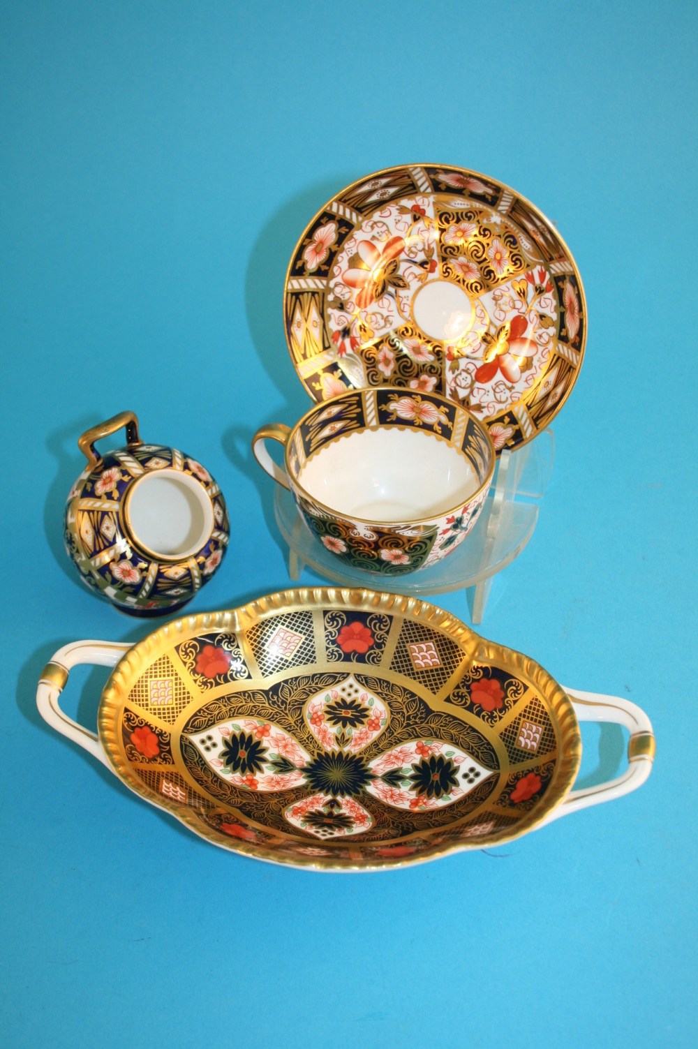 A Royal Crown Derby oblong two handled Imari dish; a small Imari scuttle; and a cup and saucer,