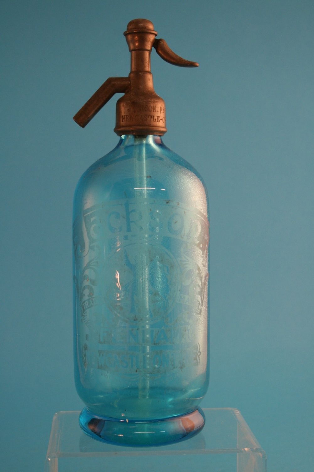 A blue glass soda syphon, acid etched "Jackson, Fenham, Newcastle-on-Tyne". 29.5 cm high