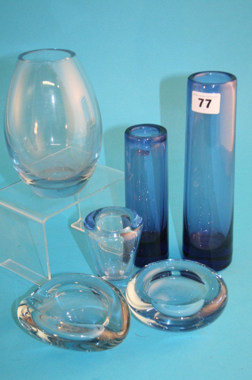 A Holmegaard blue glass cylindrical vase numbered 16910, 23 cm high; a smaller version numbered