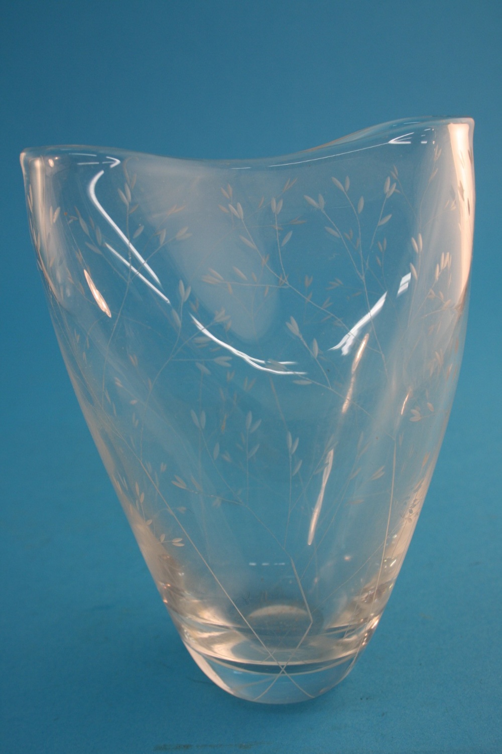 A Kosta clear glass vase designed by Vicke Lindstrand, with pinched top and engraved with