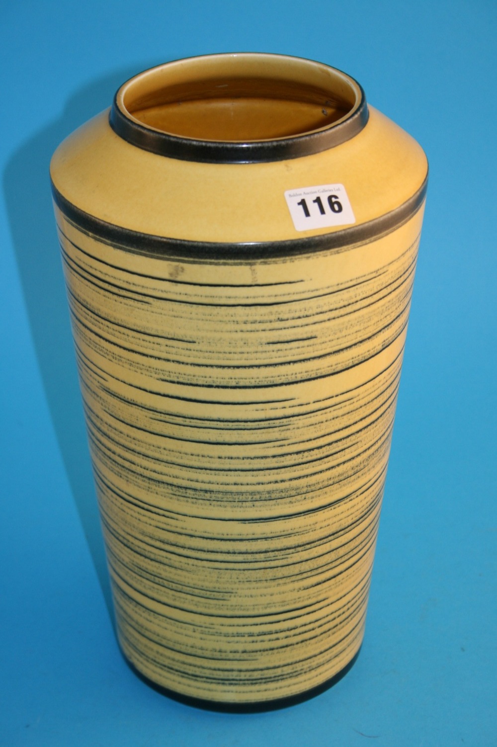 A tall tapering vase by Knabstrup of Denmark on a yellow ground, decorated with graduating