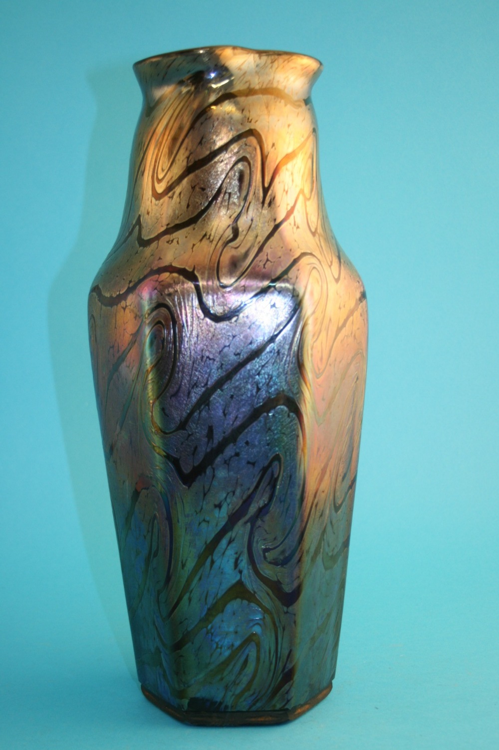 A tall Kralik iridescent vase with flared rim, waisted neck and octagonal tapering body with Art