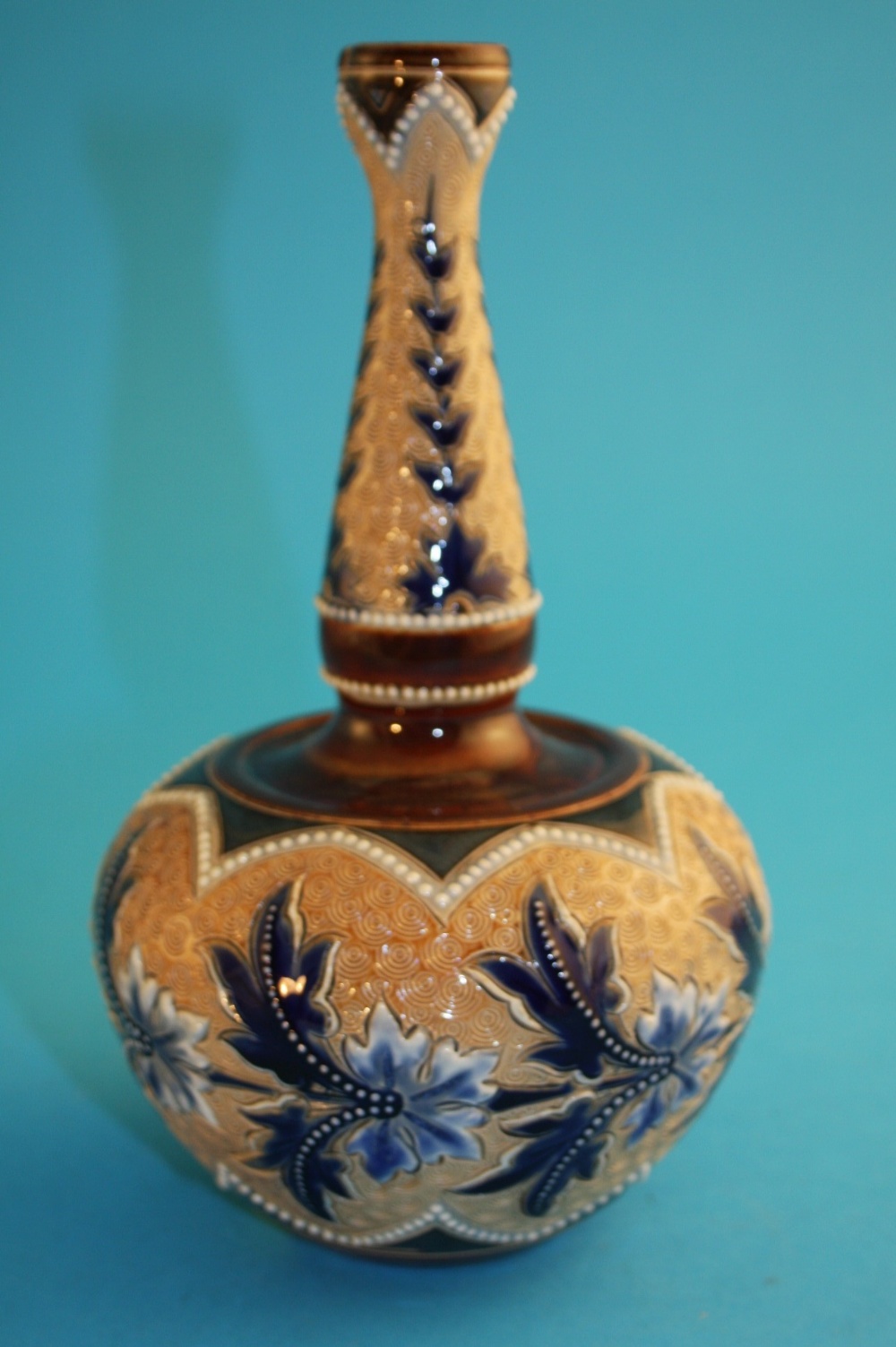 A Doulton Lambeth Art Union of London stoneware vase, with jewelled cobalt blue foliage, decorated