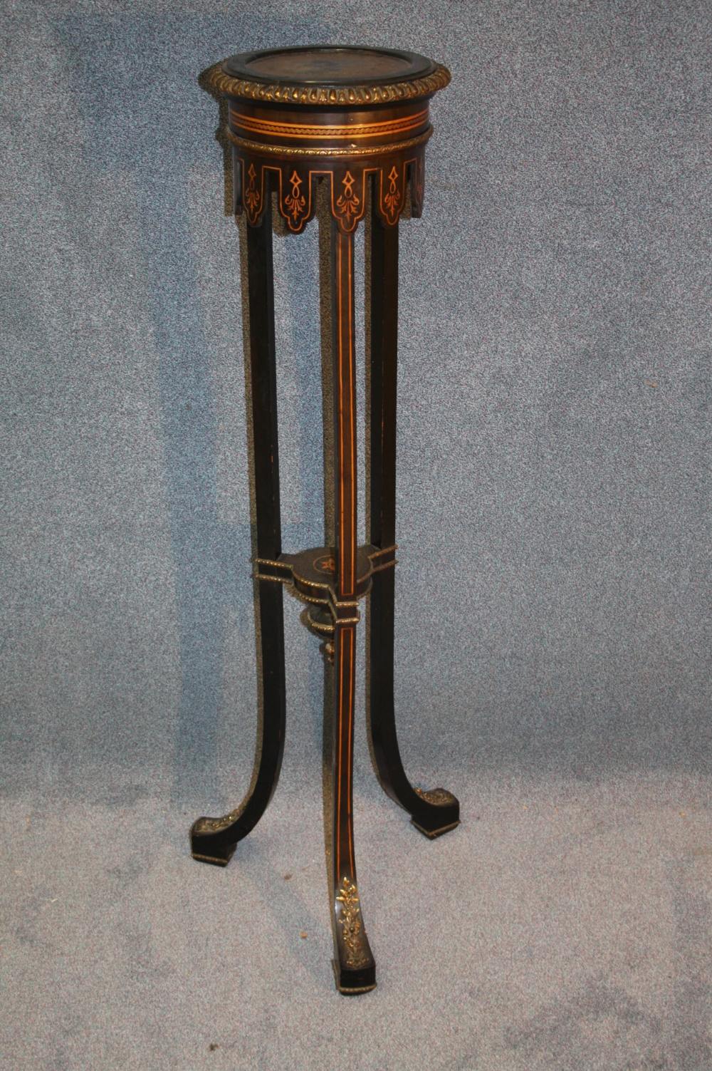 A 19th century ebonised plant pedestal with fruitwood stringing and inlays, with gilt metal edge,