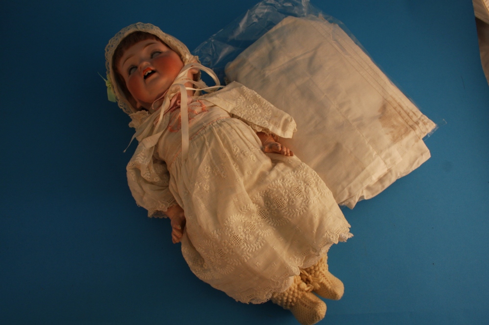 A 19th century bisque porcelain headed doll by Theador Recknagol, stamped DEP and R 4/0 A.