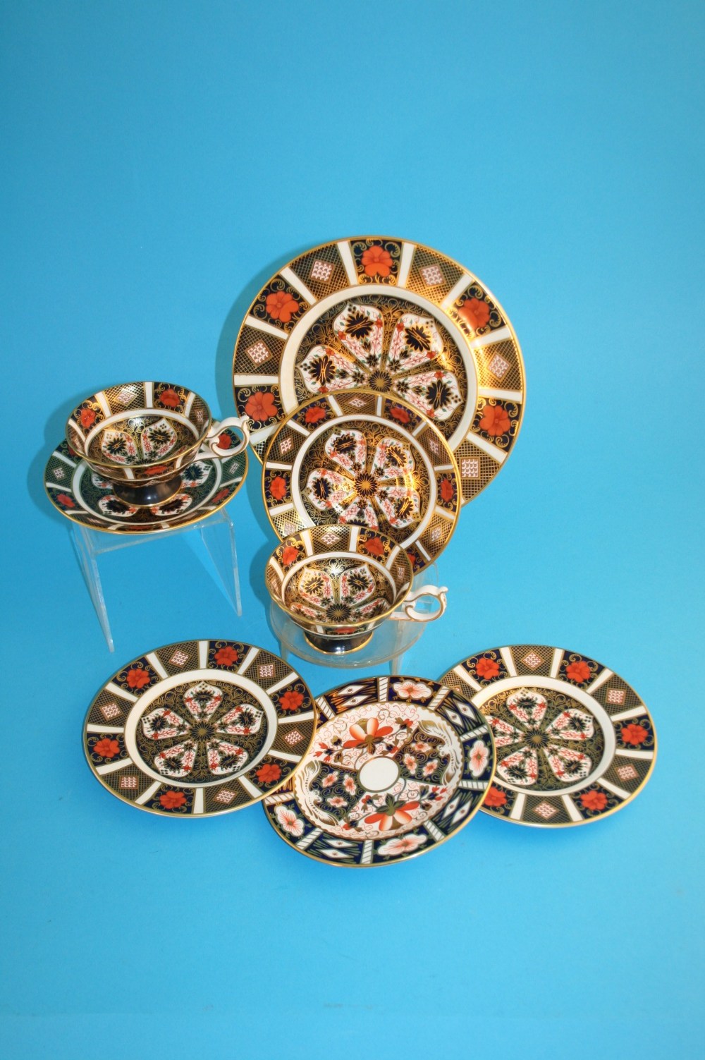 A Royal Crown Derby Imari plate, 3 side plates and two cups and saucers, printed marks numbered