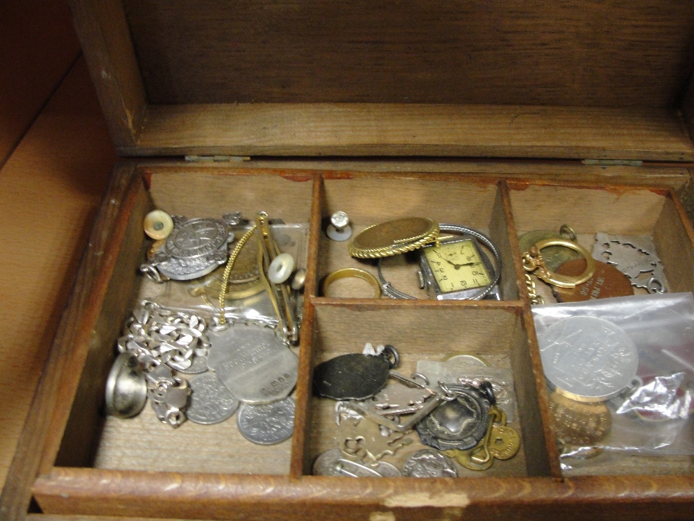 A jewellery box containing dress jewellery, silver, badges etc