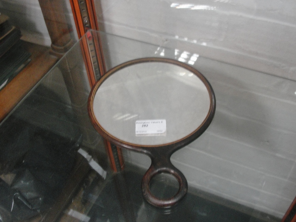 A 1930's rosewood magnifying hand mirror
