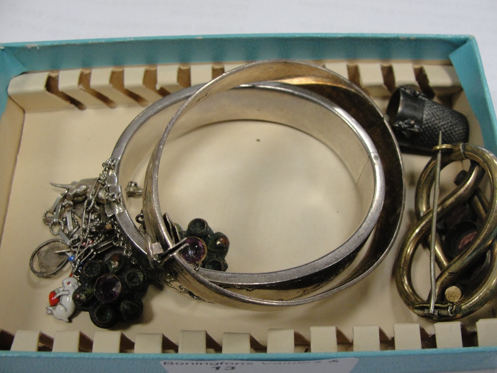 A quantity of silver bangles, charm bracelets and brooches