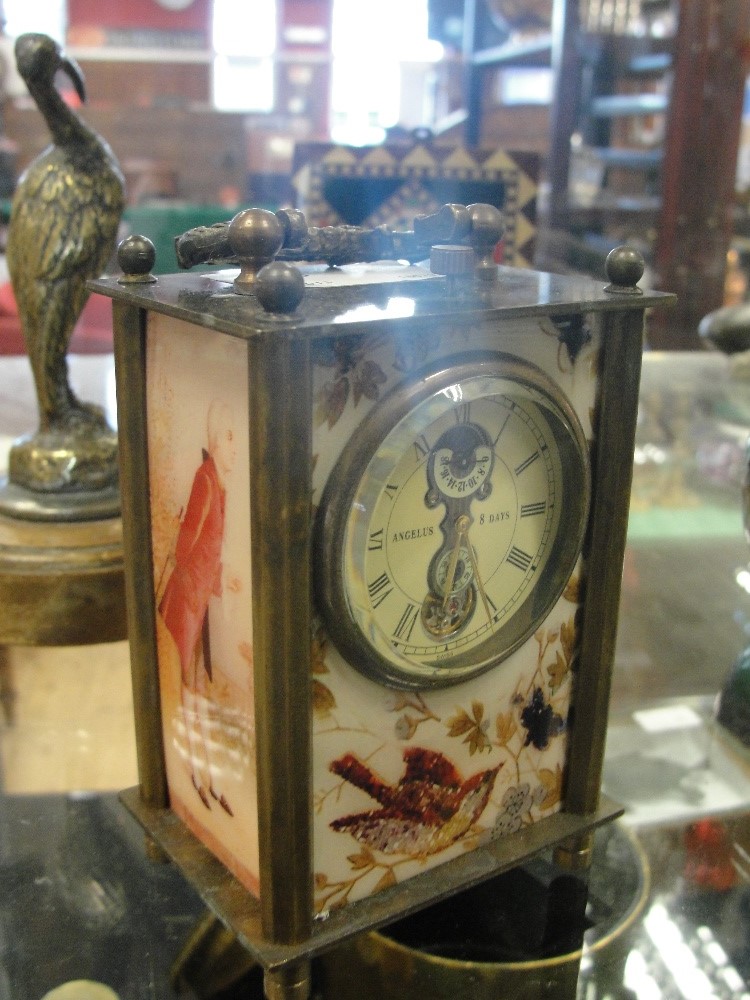 A small carriage clock with porcelain panels