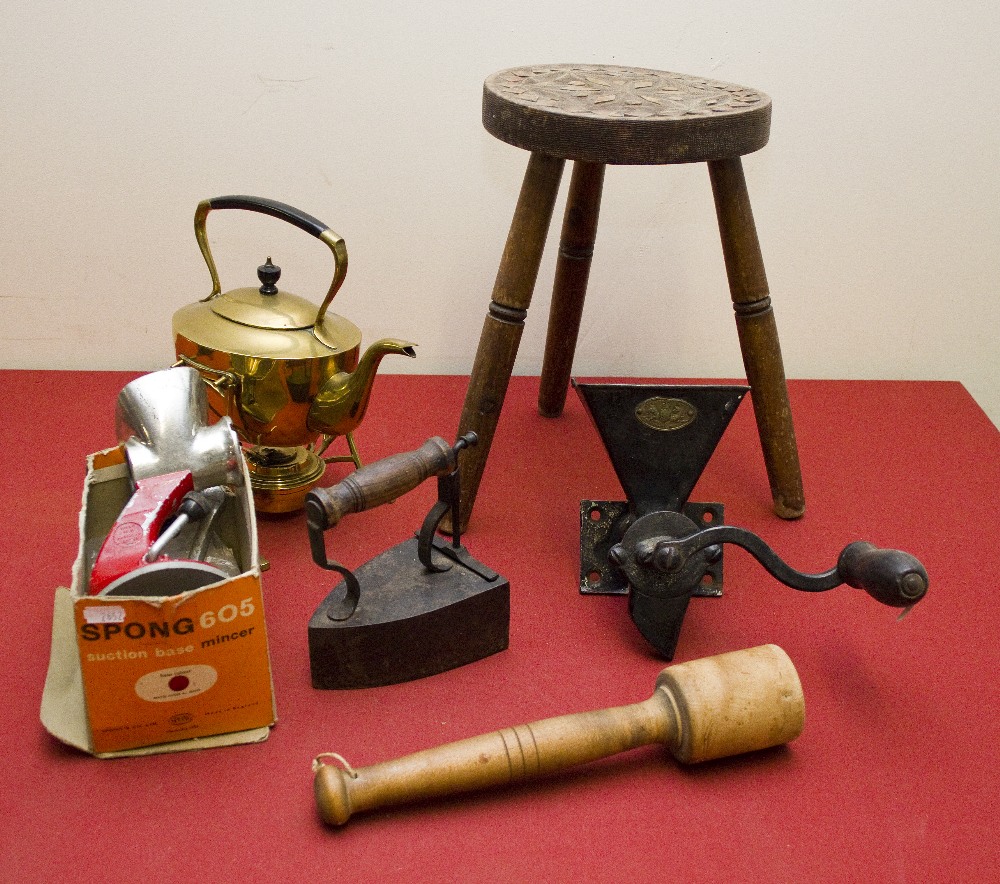 A brass spirit kettle, two mincers, flat iron and a stool