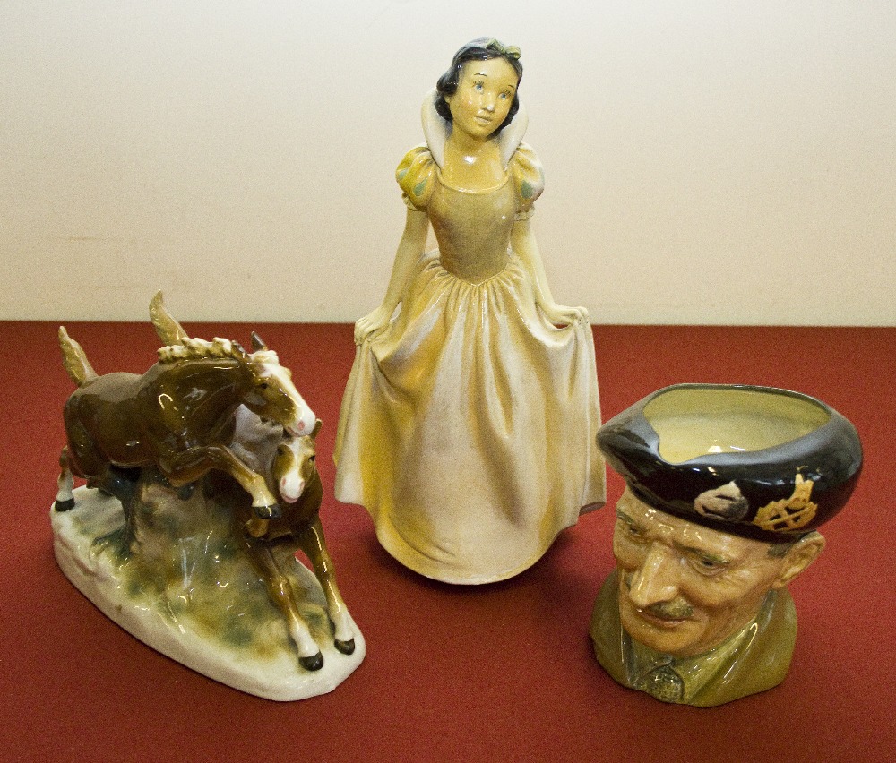 A Snow White chalk figure, Monty character jug and a continental figure group