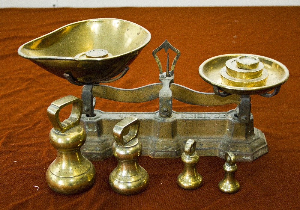 A set of scales with brass weights.