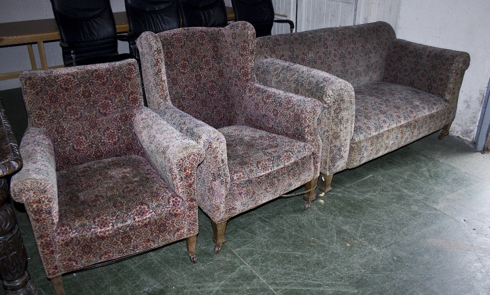 An Edwardian upholstered sofa and two armchairs