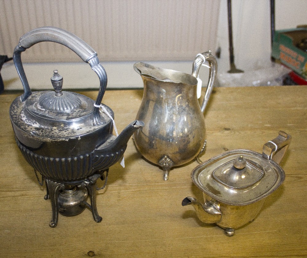 A silver plated water jug, teapot and spirit kettle