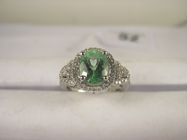 A large Paraiba Tourmaline and diamond cluster ring, Tourmaline 2.35cts.