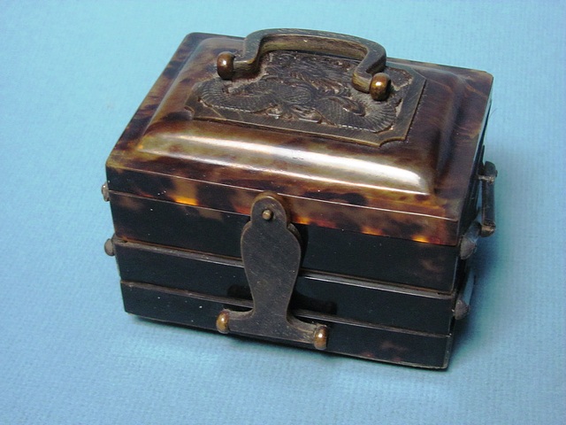A tortoiseshell folding trinket box with pierced top panel over sections, A/F.
