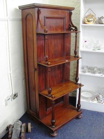 A 19th century mahogany panelled table leaf cabinet with what not front having turned supports.