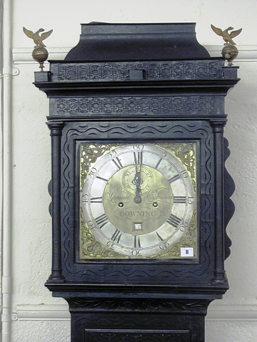 Samuel Collings, Downing, a 19th century long case in ornate carved case, brass dial and finials.