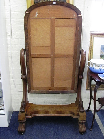 A flame mahogany 19th century arched topped cheval dressing mirror on trestle end supports.
