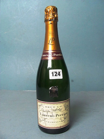 A bottle of Laurent Perrier Champagne signed by famous figures.